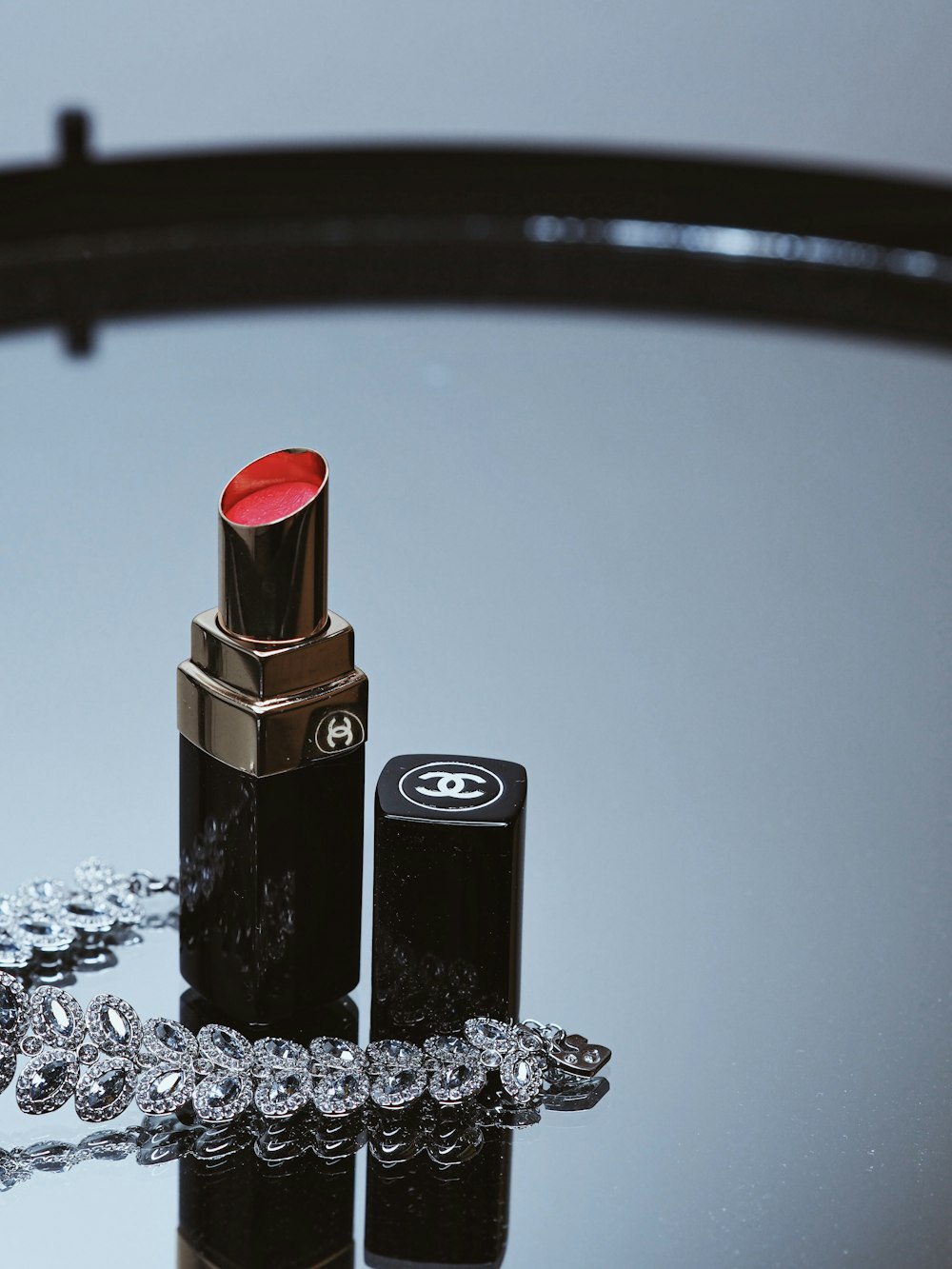 black and red lipstick on black and white table