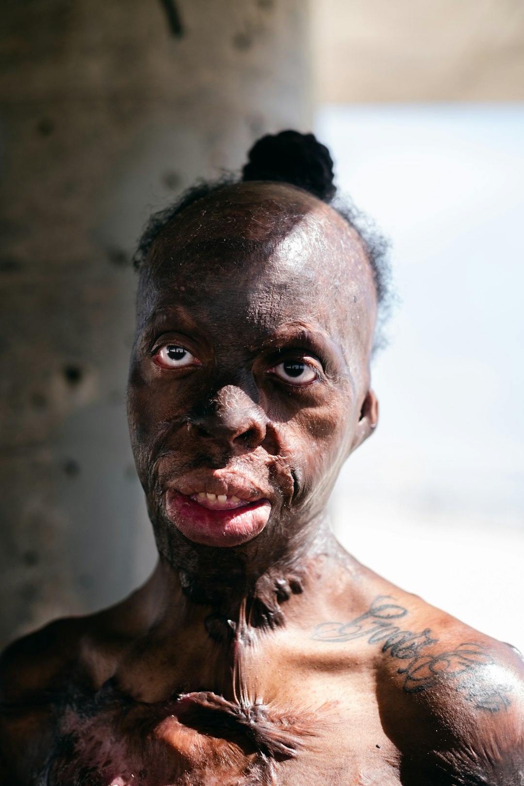 topless man with white powder on his face