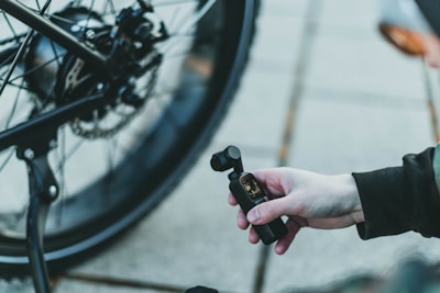 A behind-the-scenes shot showing a dad recording a funny cycling video for social media, with his bike in the background.