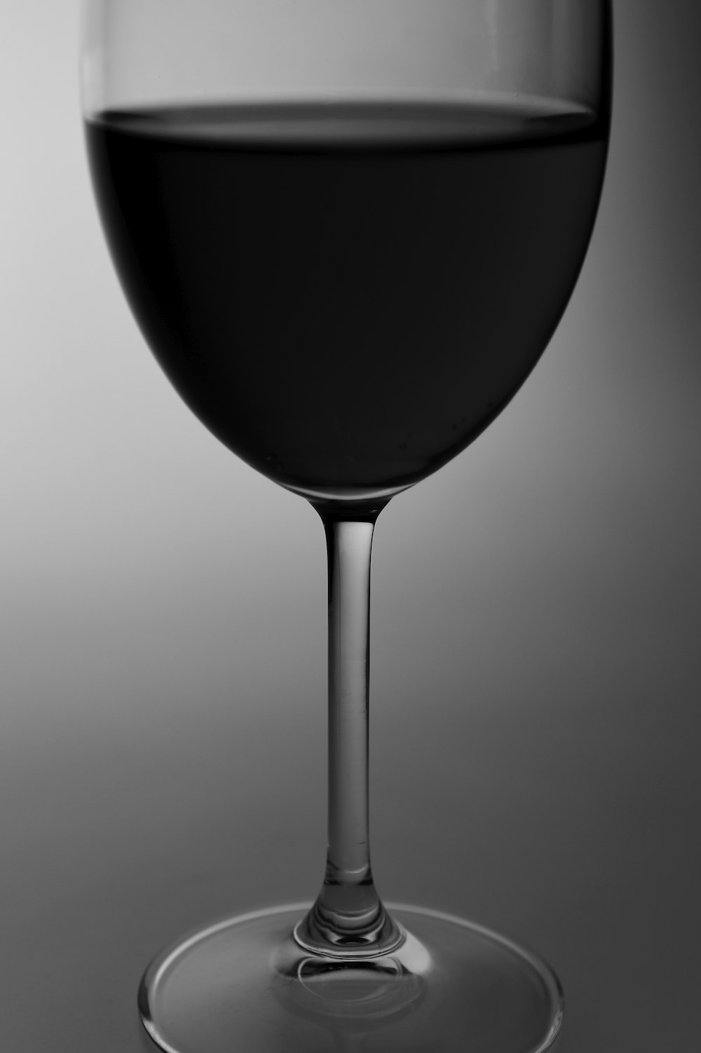 black wine glass on white surface