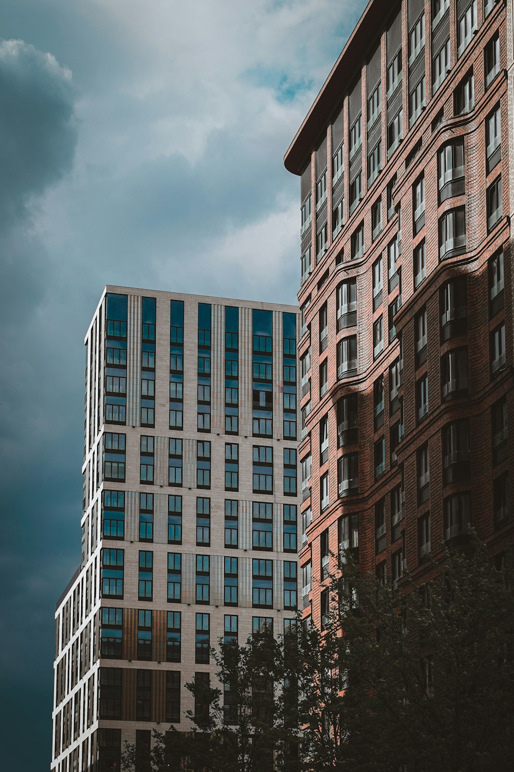 white and brown concrete building under white clouds during daytime