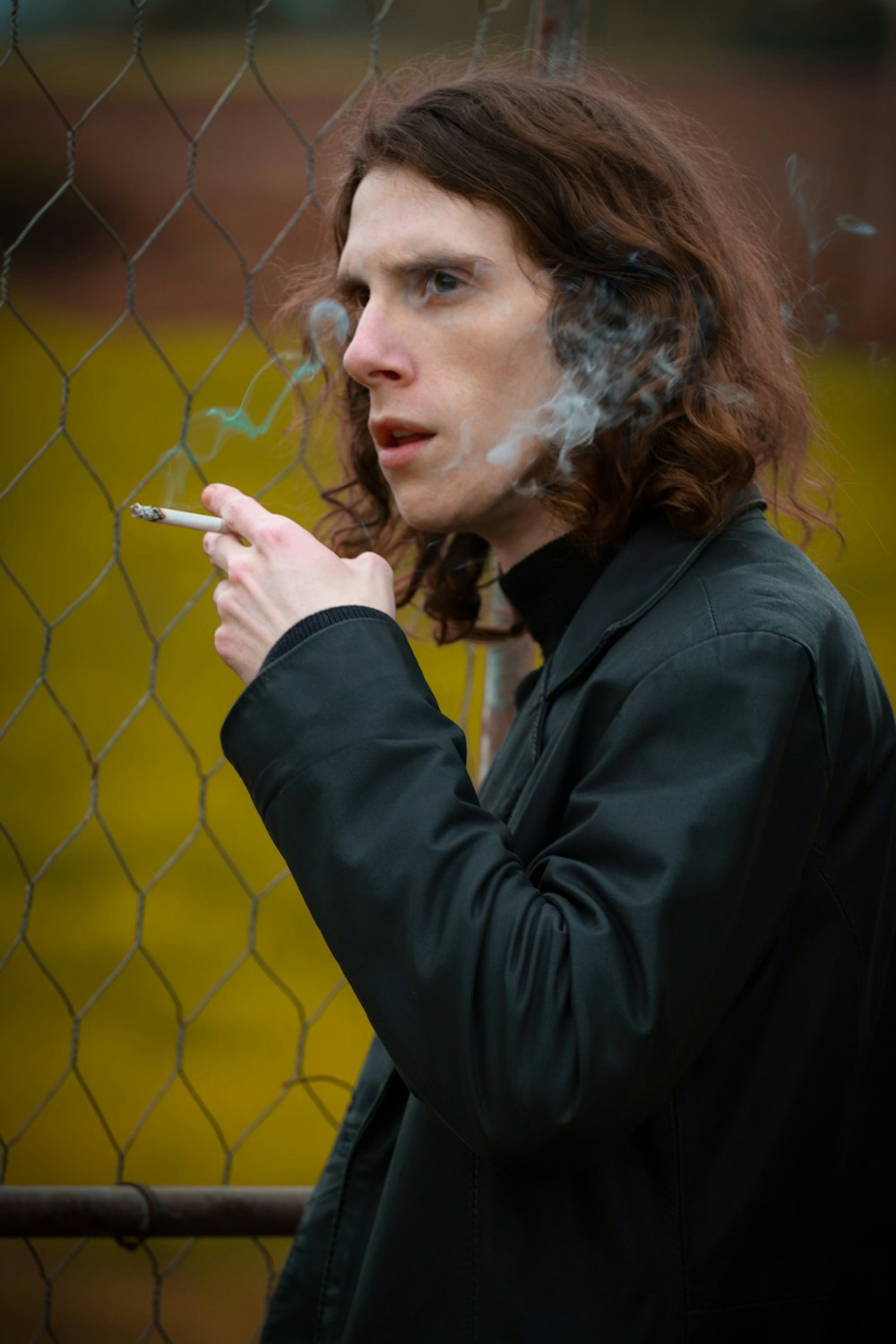 woman in black blazer smoking cigarette
