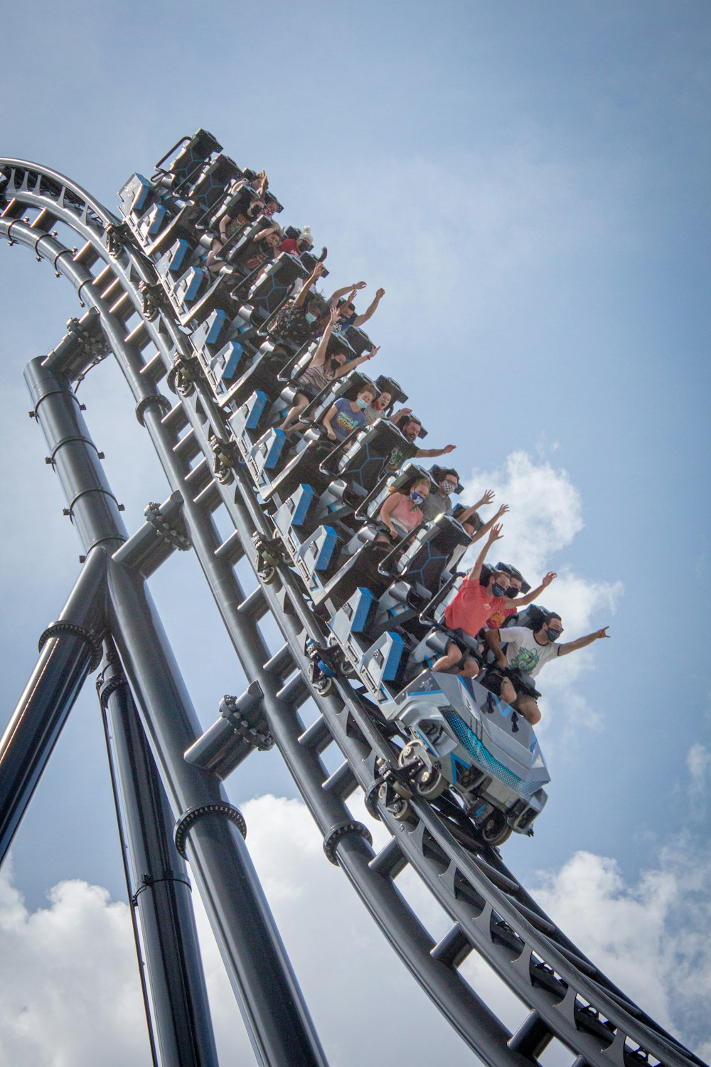 people riding on roller coaster during daytime