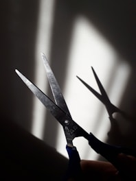 black handle scissors on white surface