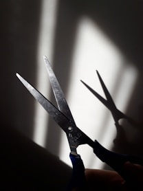 black handle scissors on white surface