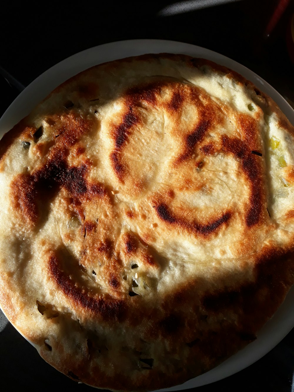 brown and white pie on black plate