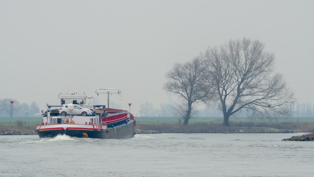 red and white boat on body of water during daytime