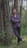 man in black pants standing beside tree