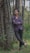 man in black pants standing beside tree