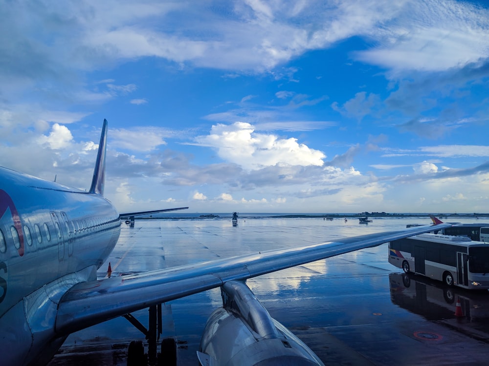 white airplane under white clouds during daytime