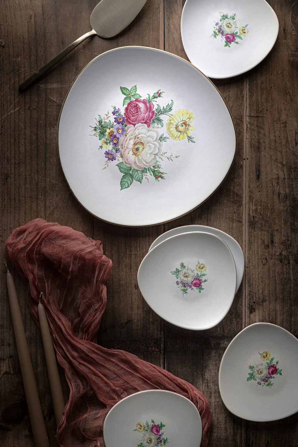 white green and red floral round ceramic plate