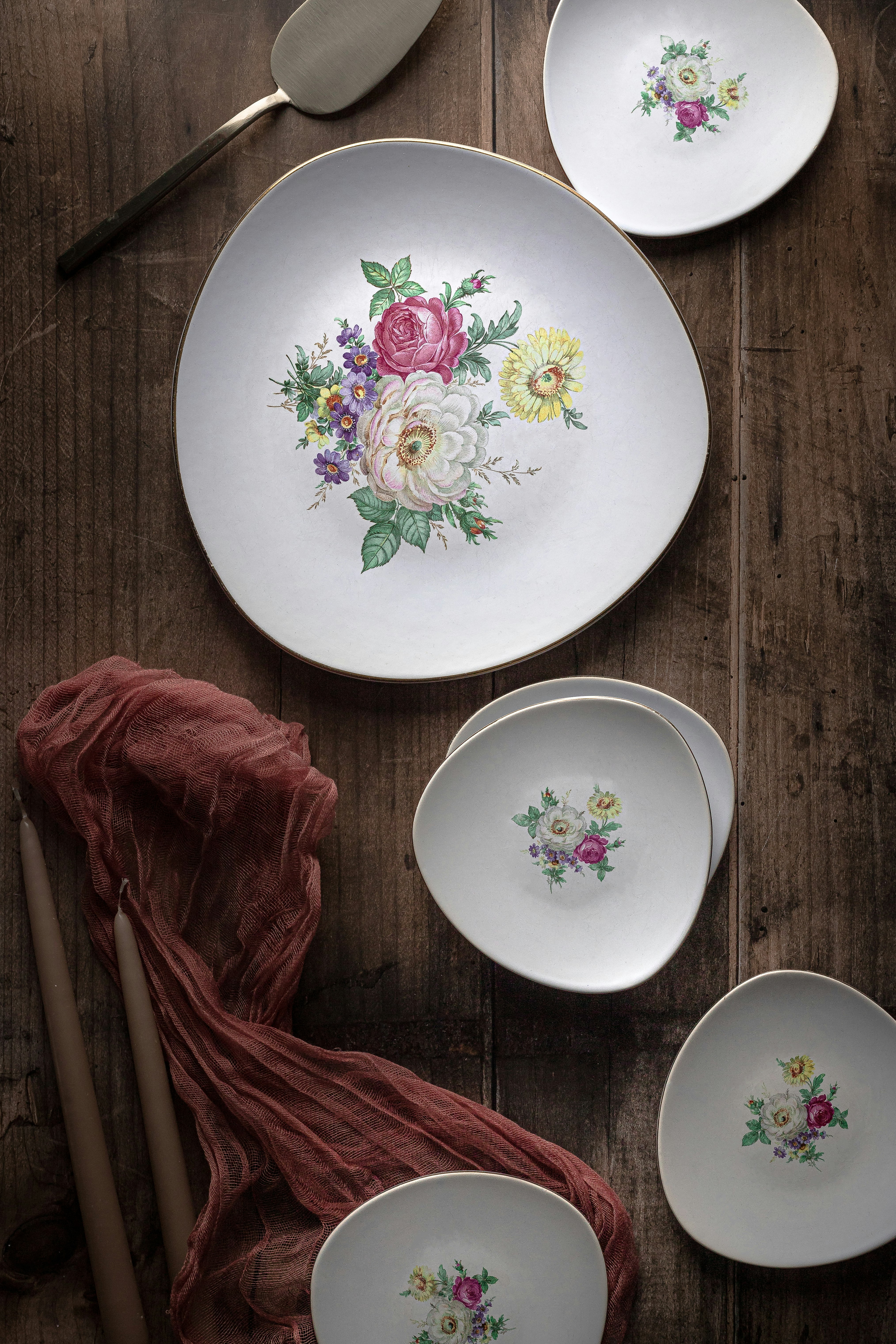 white green and red floral round ceramic plate
