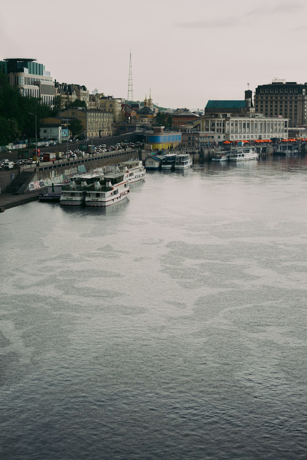 white boat on water near city buildings during daytime