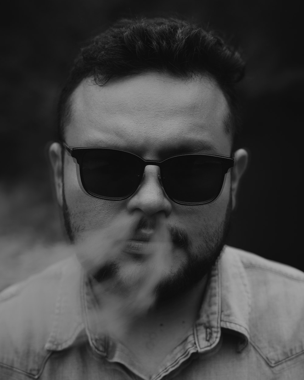 man wearing black sunglasses and white collared shirt