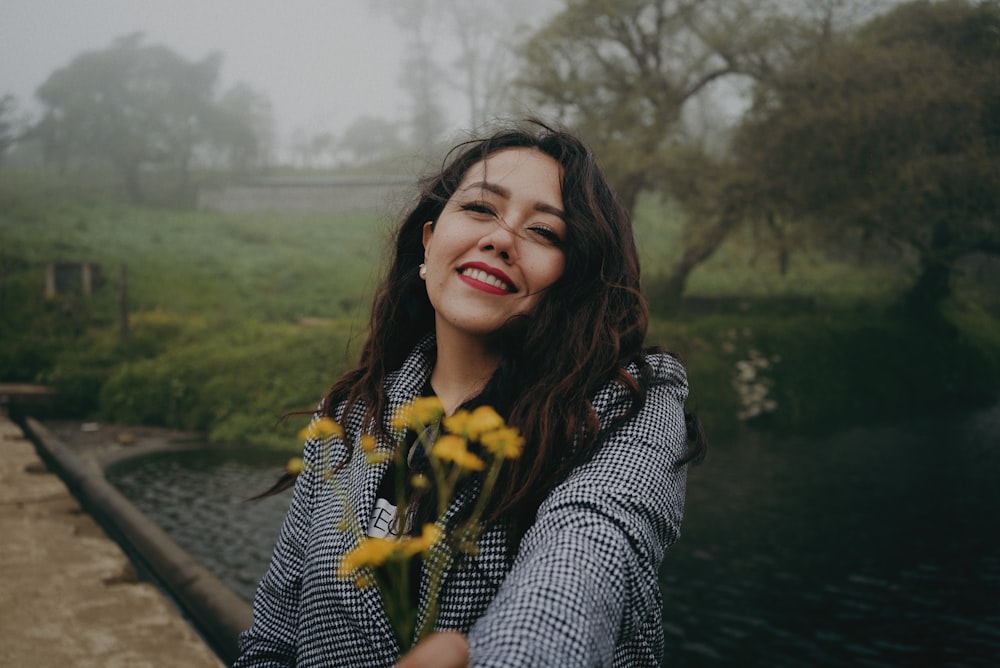 woman in black and white long sleeve shirt smiling