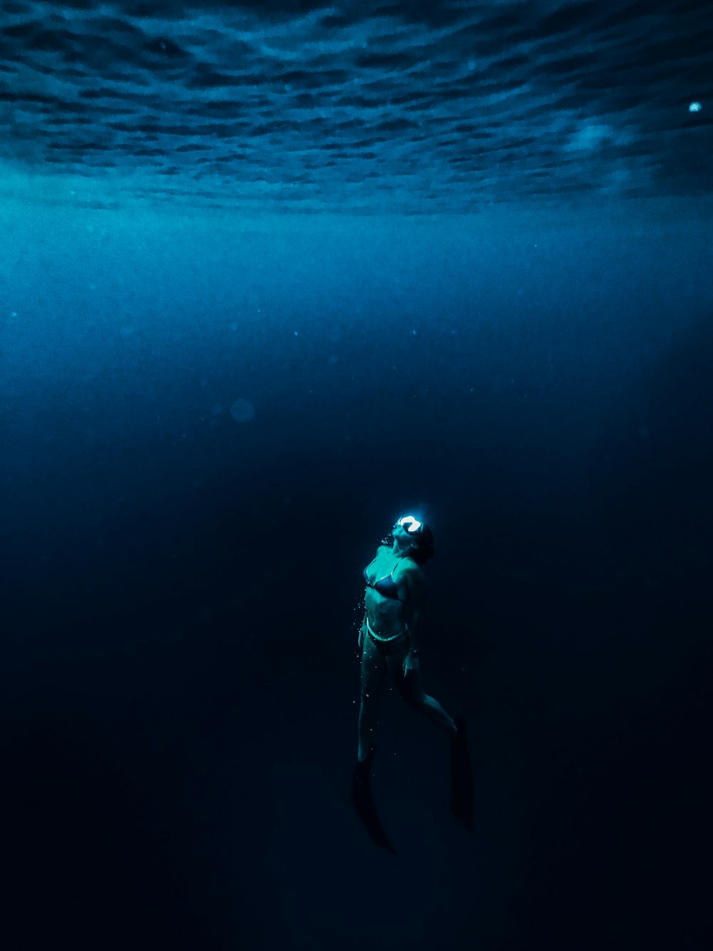 man in blue and white jacket and black pants in water