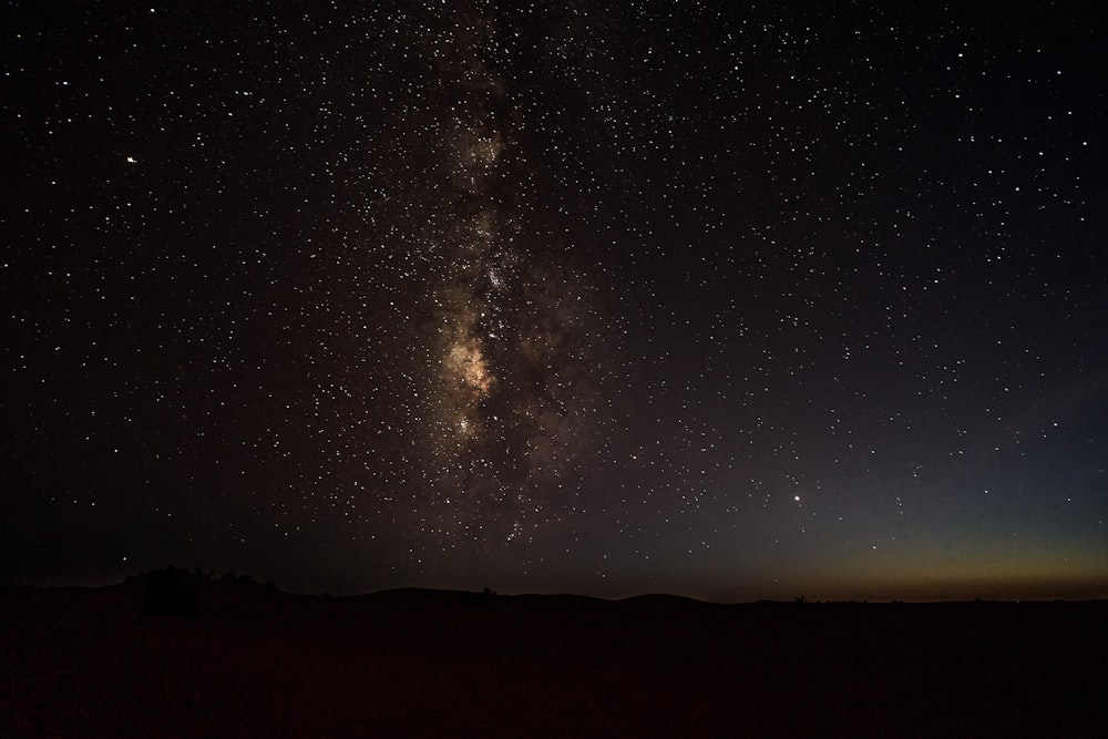 silhouette of mountain under starry night