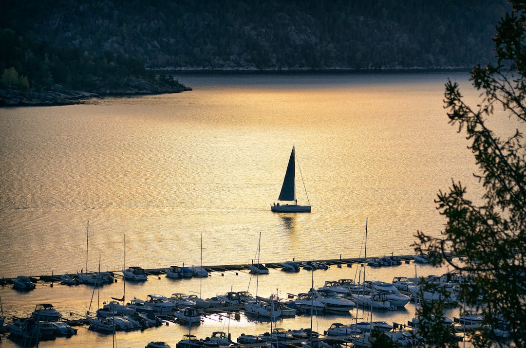 white sail boat on body of water during daytime