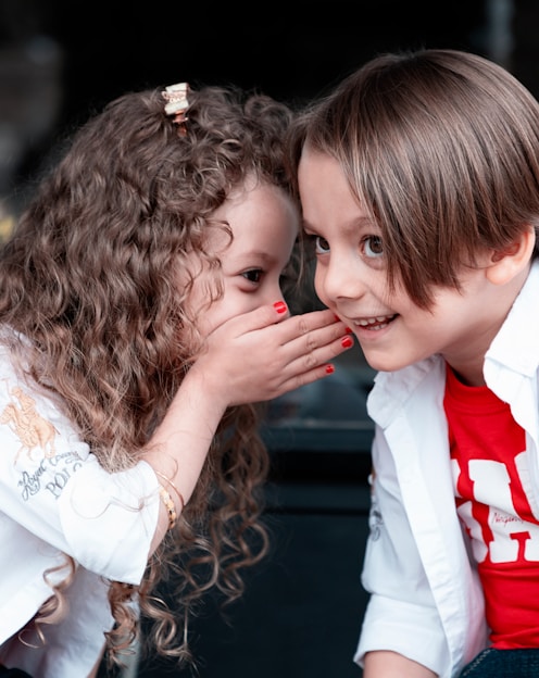 woman in white long sleeve shirt kissing girl in white long sleeve shirt