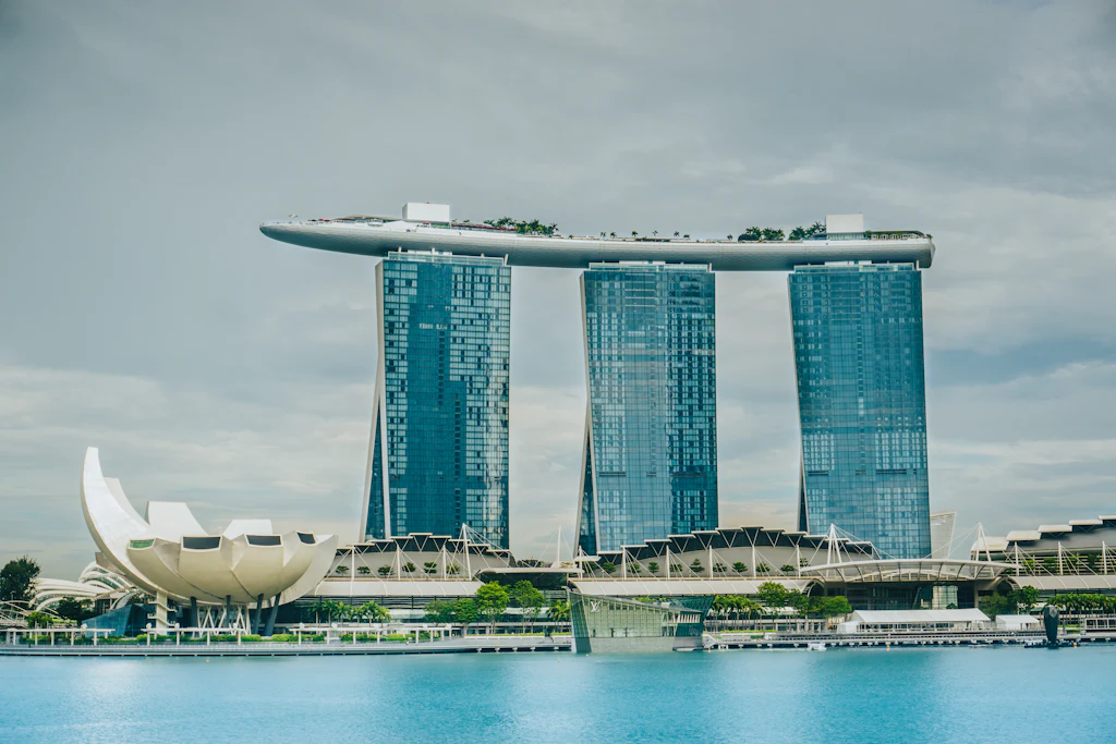 Marina Bay waterfront with Marina Bay Sands and the ArtScience Museum under a pale sky