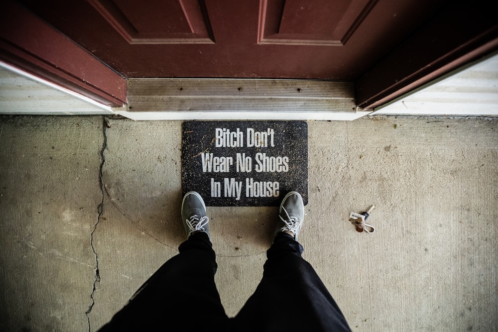 person in black pants and blue sneakers