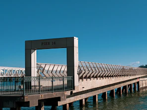Finished pier with clean lines and polished surfaces reflecting a clear sky.