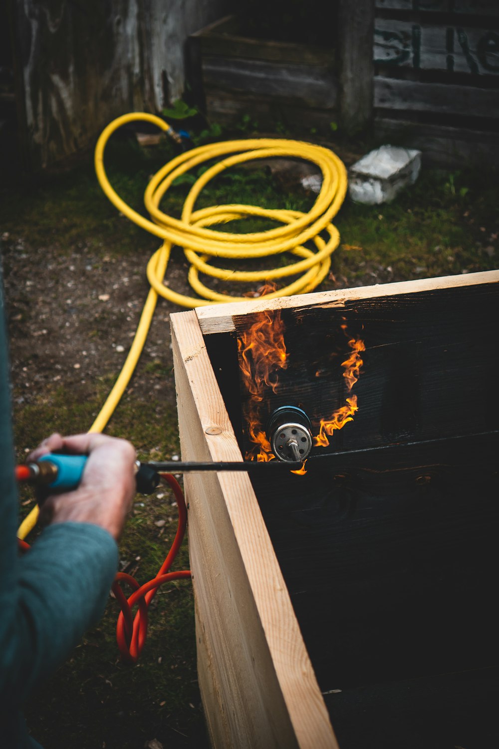 person holding orange coated wire