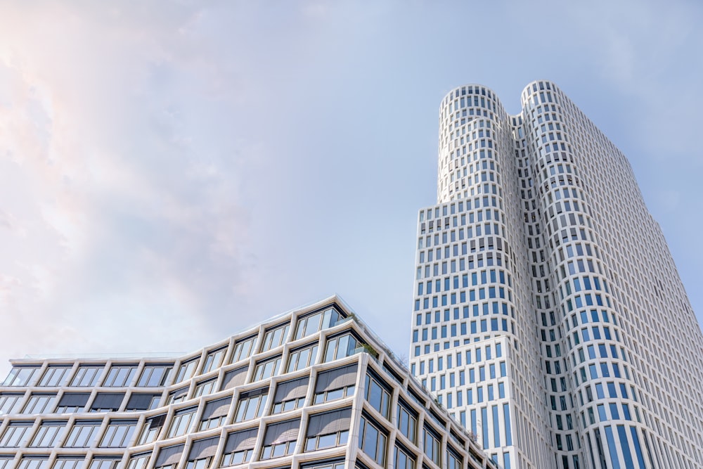 white and blue glass walled high rise building