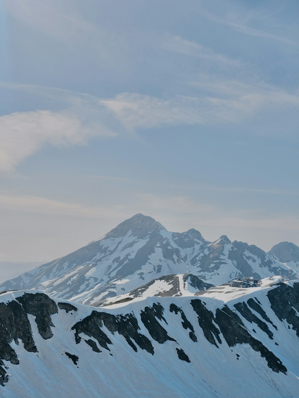 snow covered mountain under cloudy sky during daytime