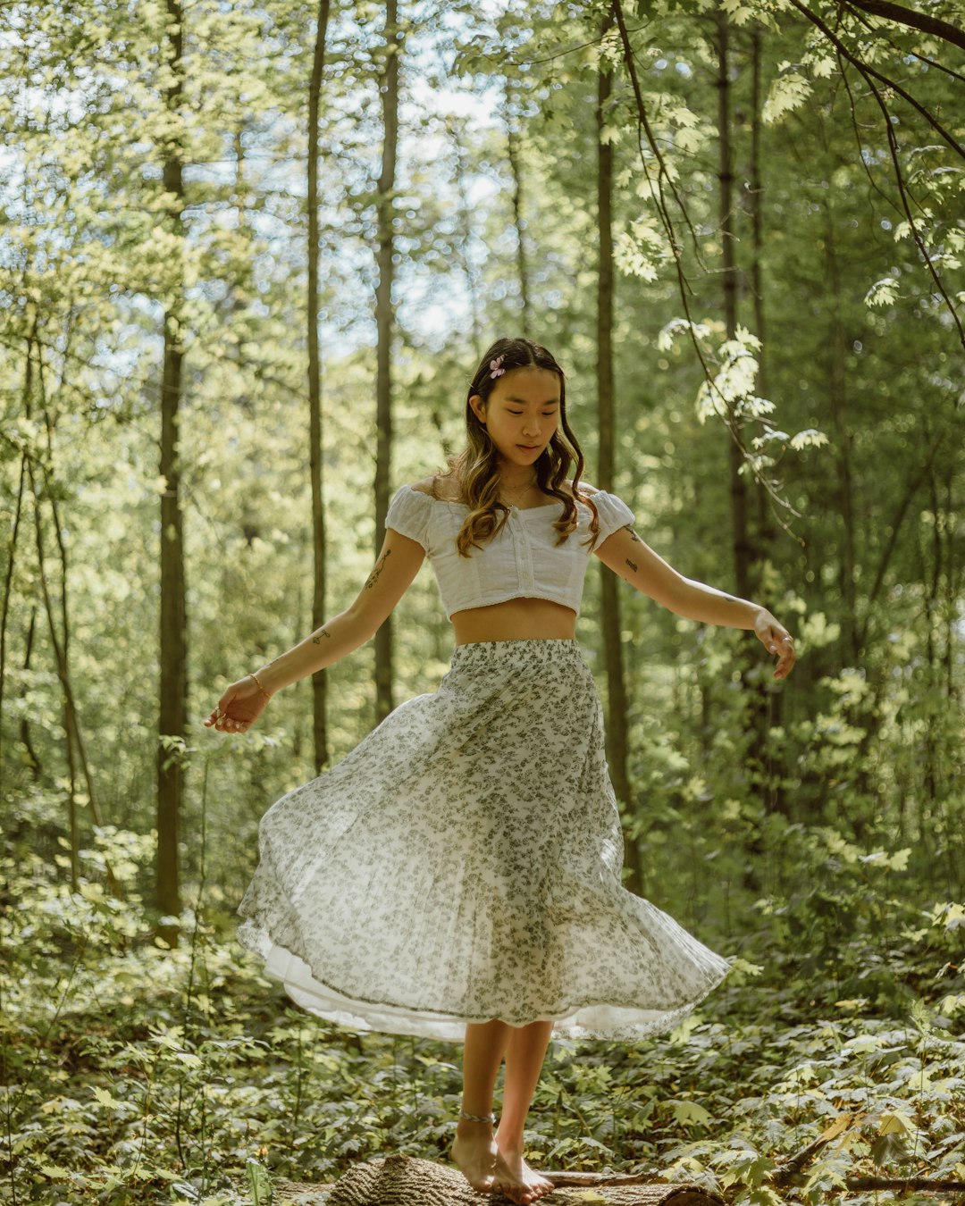 woman in white dress standing on forest during daytime