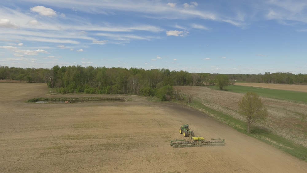 green trees and brown field under blue sky during daytime