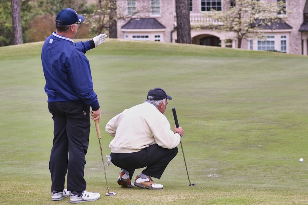 man in blue long sleeve shirt and black pants playing golf during daytime