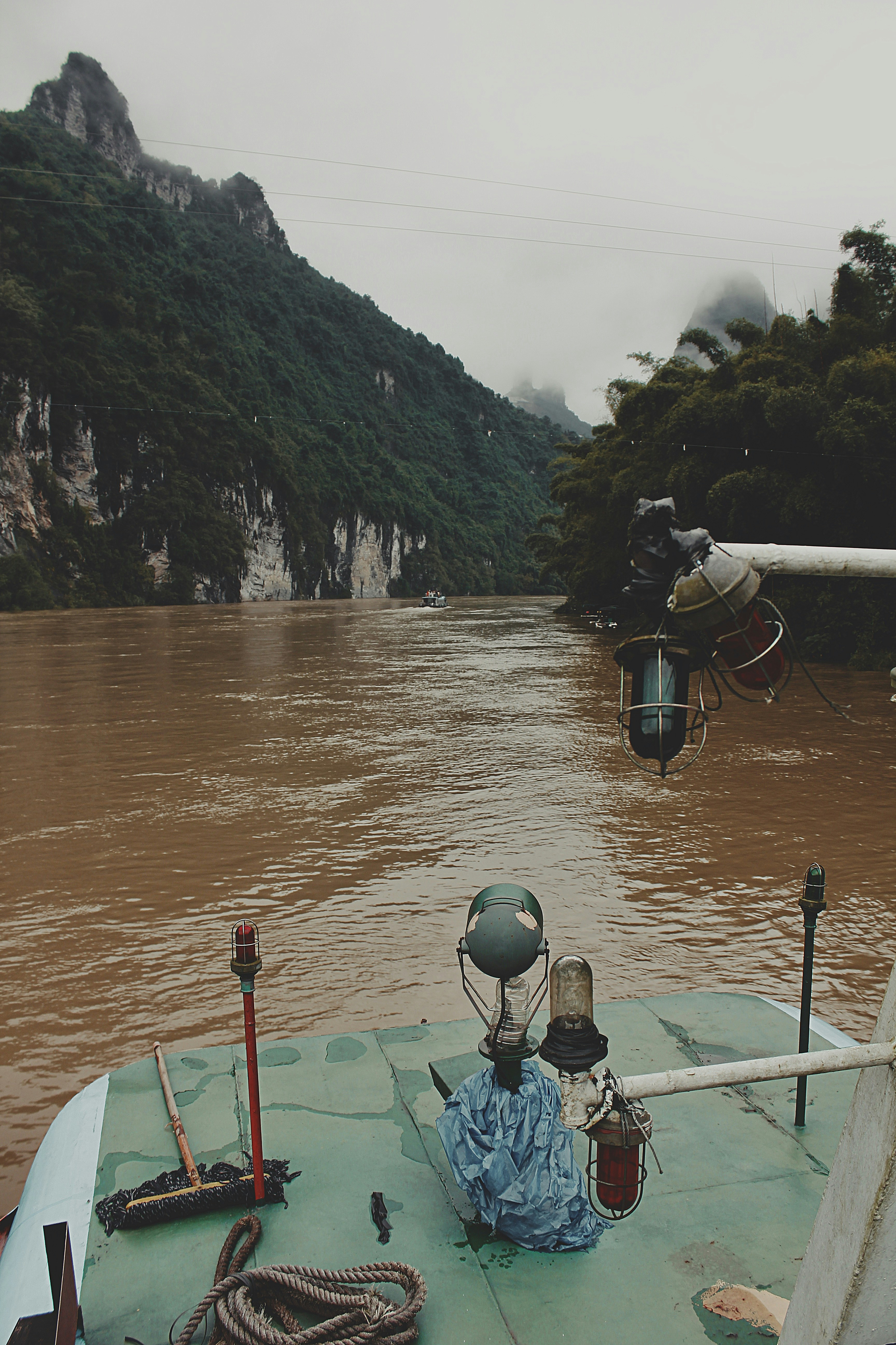 Hippo hunt Zambezi River Zimbabwe, boat approach, murky water, overcast dramatic sky