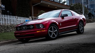 red bmw m 3 coupe parked on gray asphalt road during daytime