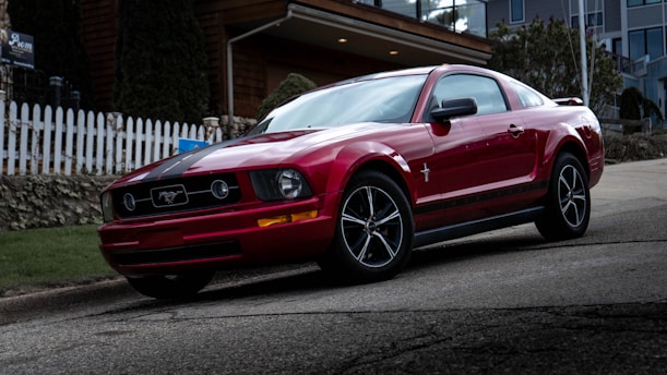 red bmw m 3 coupe parked on gray asphalt road during daytime