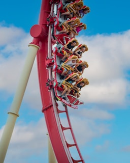 people riding roller coaster during daytime