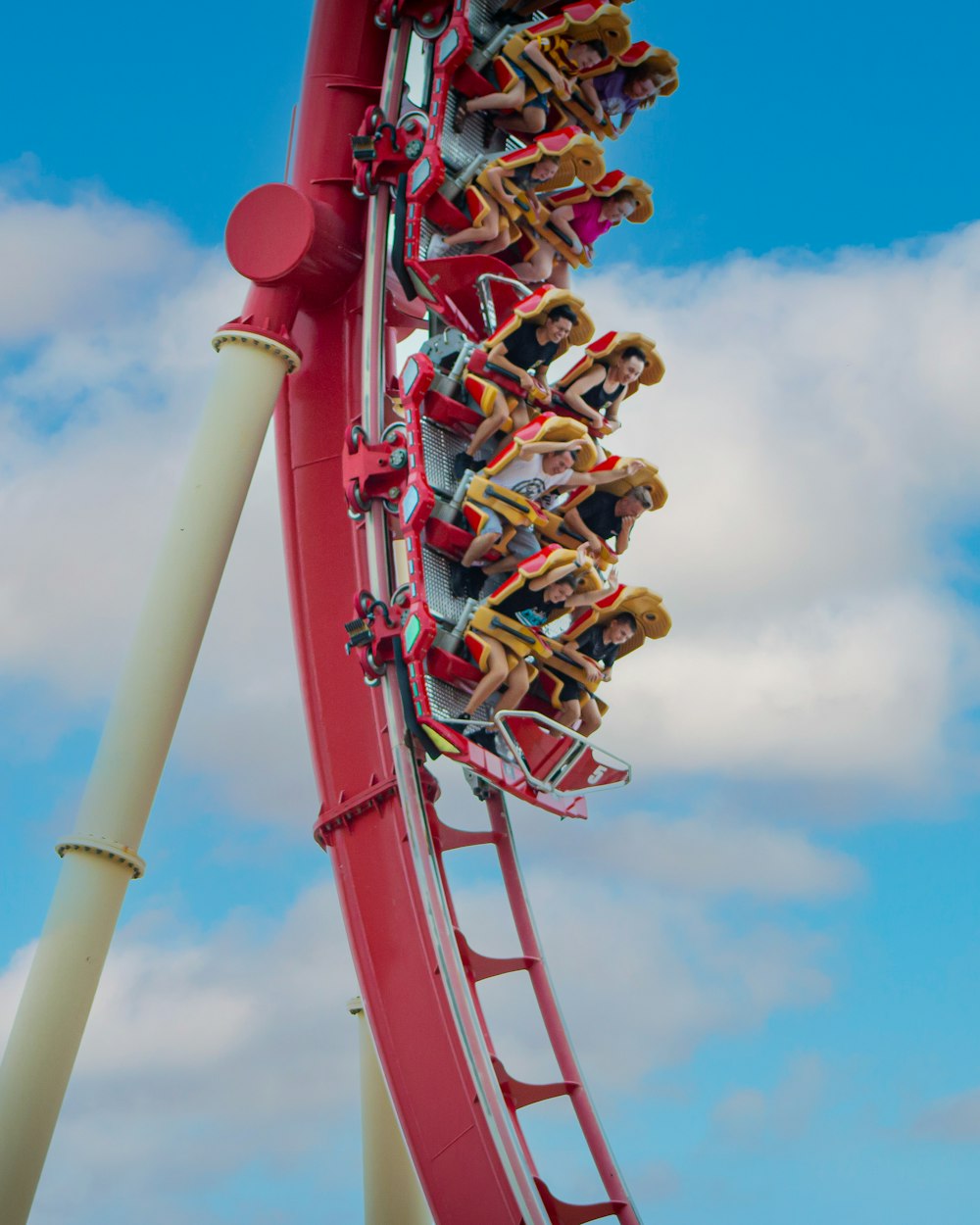 people riding roller coaster during daytime