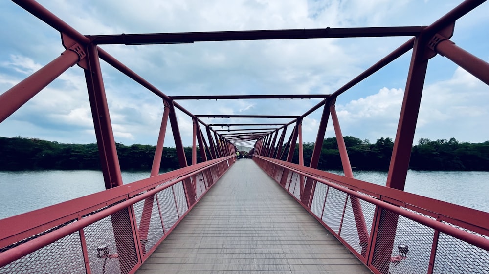 brown wooden bridge over body of water during daytime