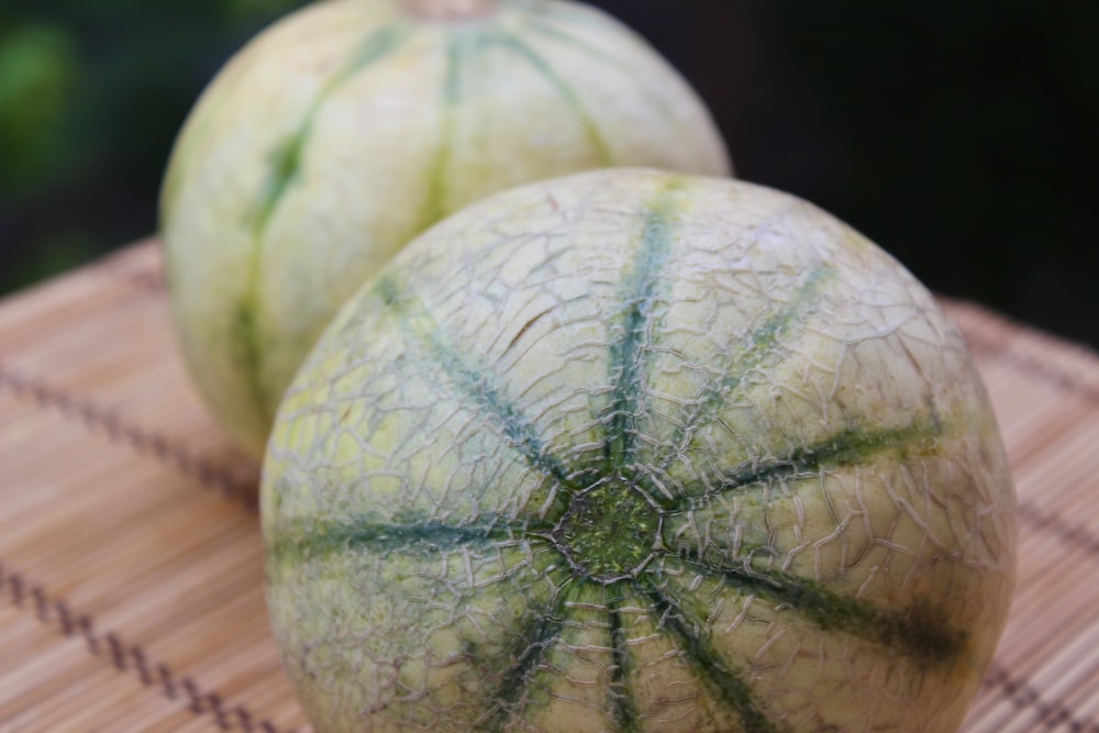 green watermelon on brown wooden table