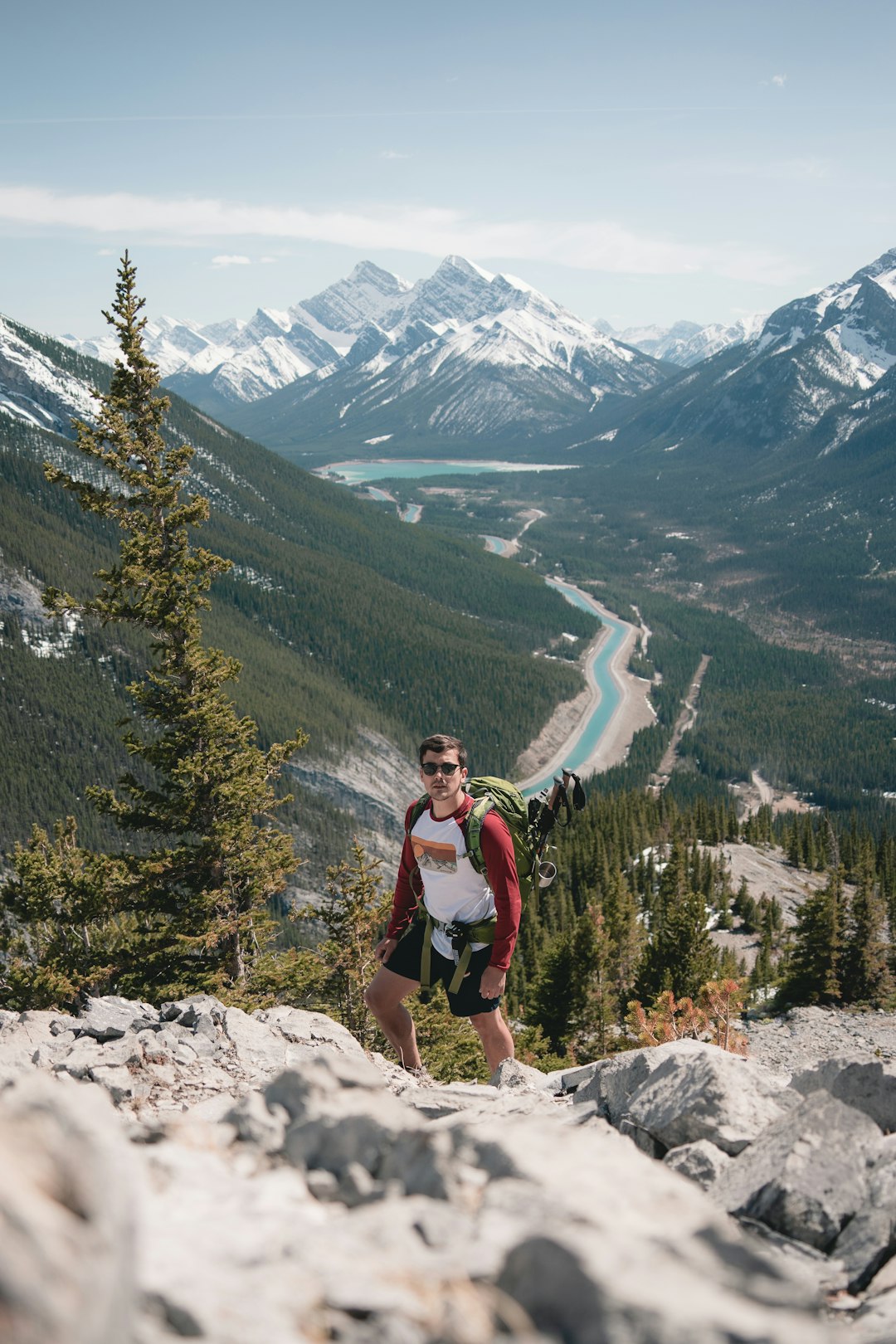 woman in red jacket standing on rocky mountain during daytime