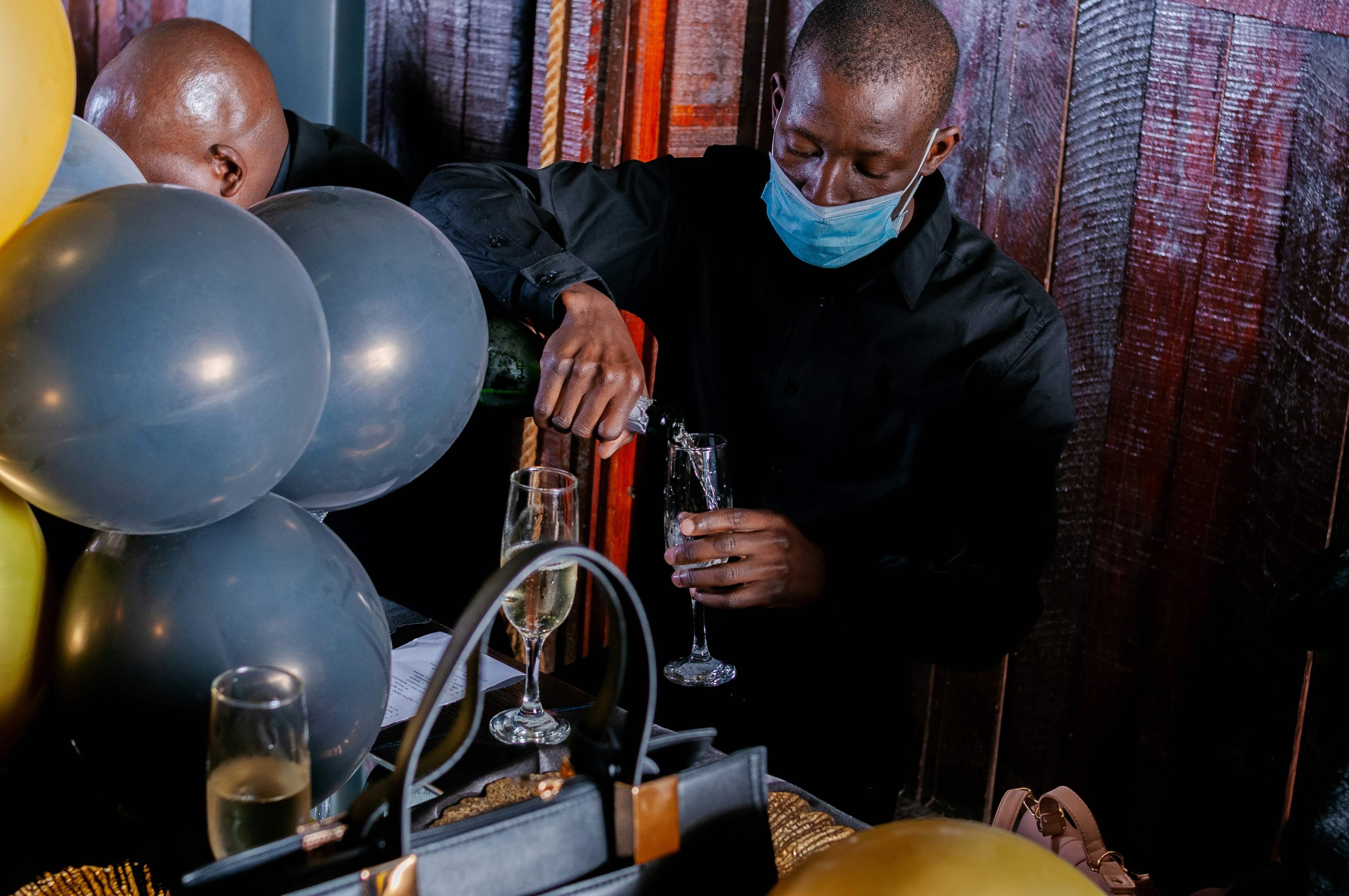 man in black jacket holding silver trophy
