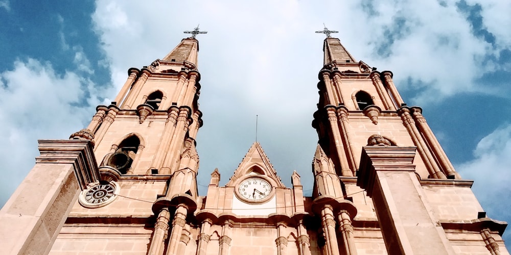 brown concrete church under white clouds during daytime