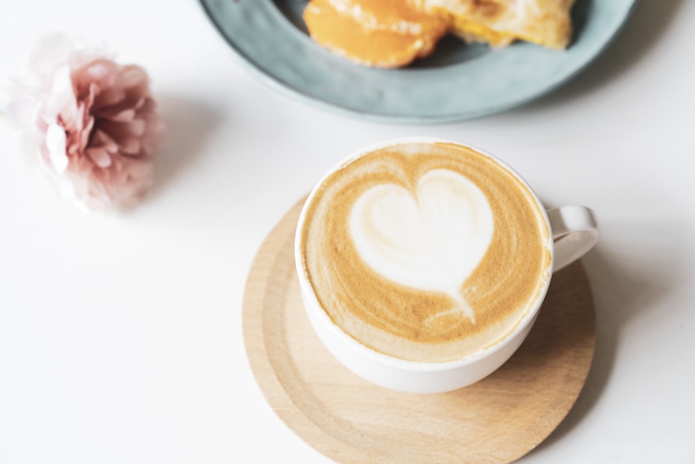 white ceramic cup with cappuccino