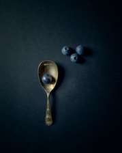 silver spoon on black surface