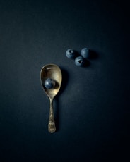 silver spoon on black surface