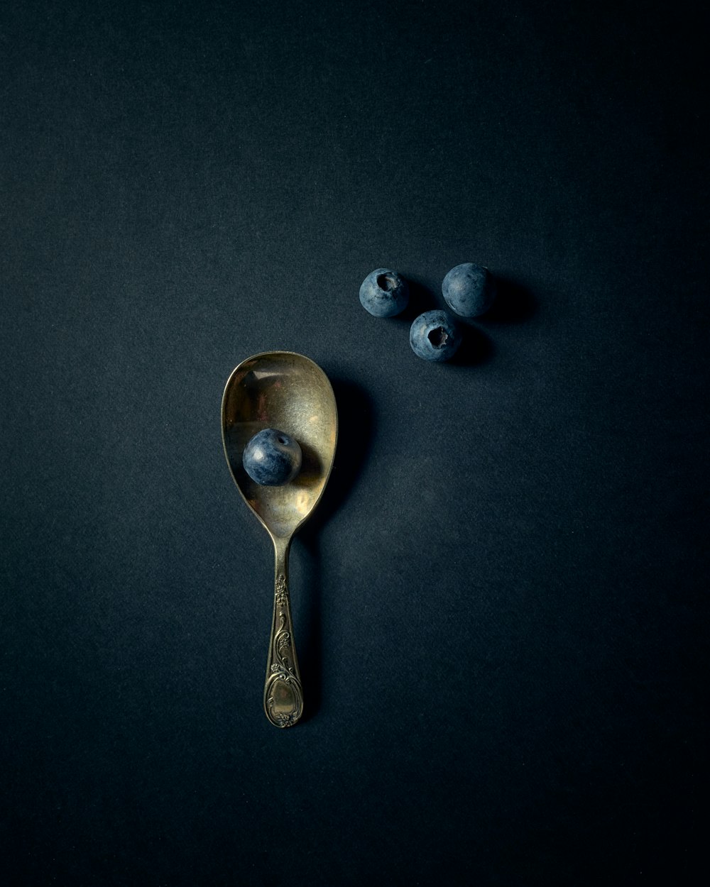 silver spoon on black surface