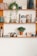 green potted plant on white wooden shelf