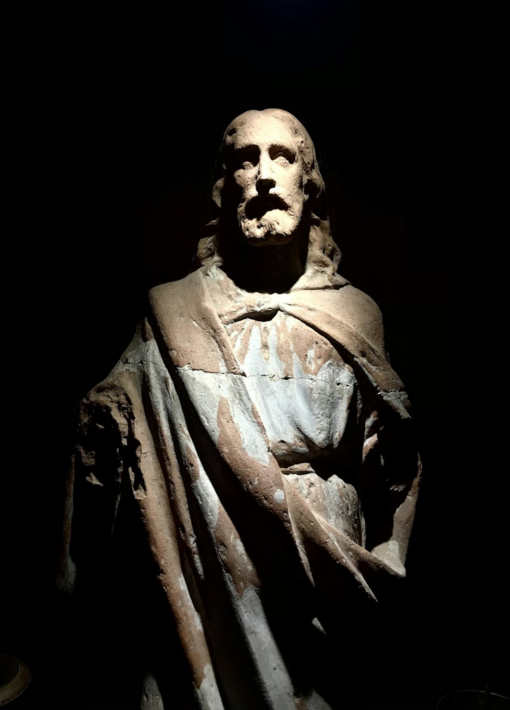 man in black coat statue