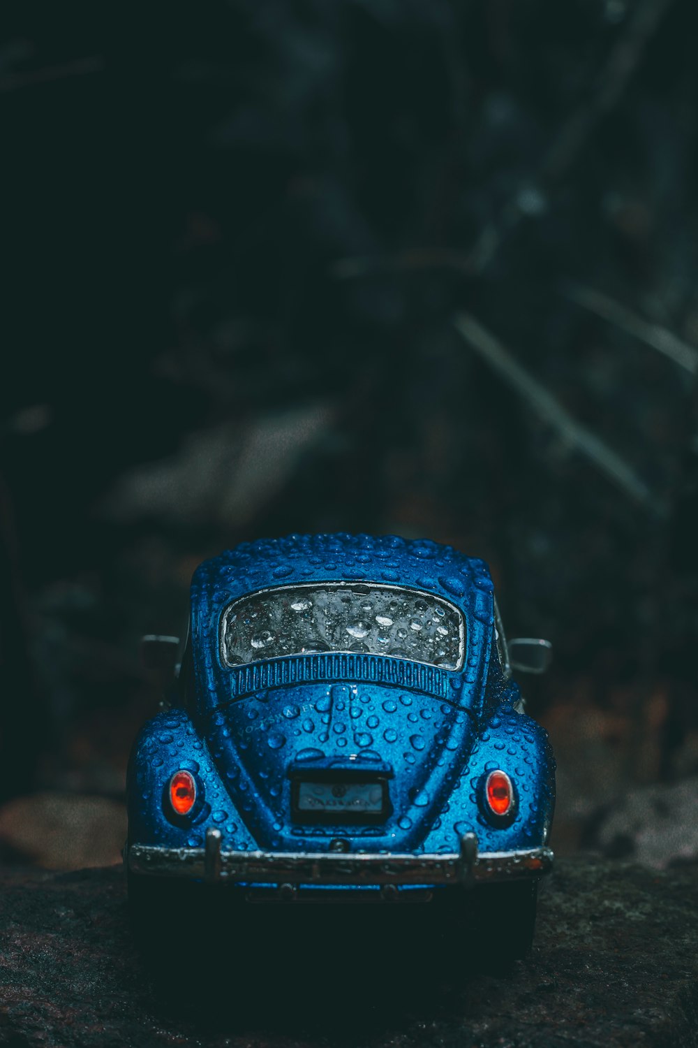 blue volkswagen beetle on brown soil