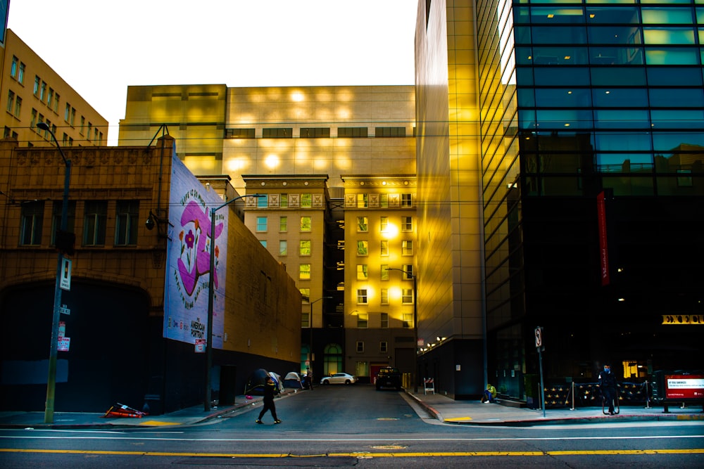 people walking on pedestrian lane near high rise building during night time